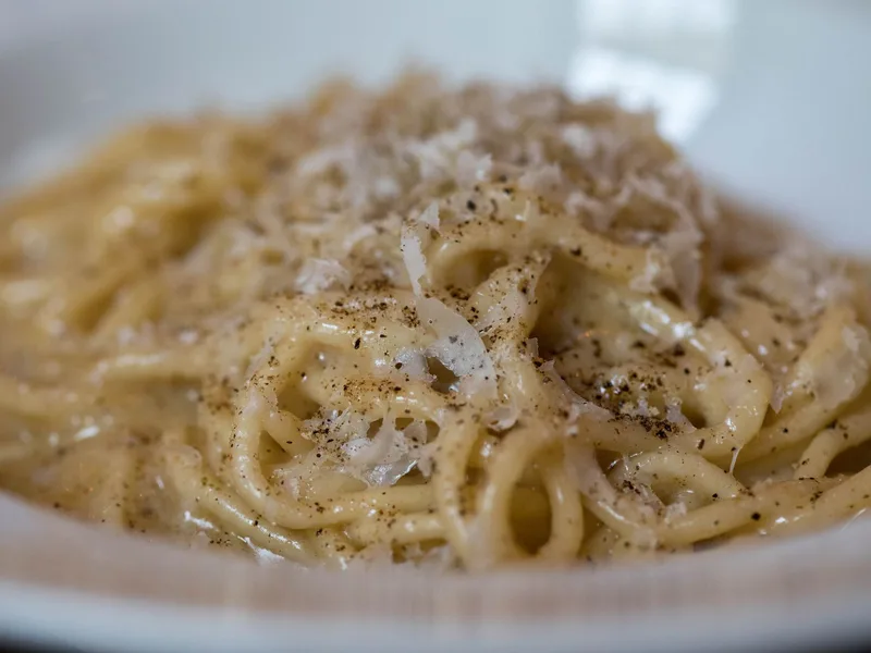 Cacio e pepe tossed tableside in a Parmesan wheel at Felice a Testaccio