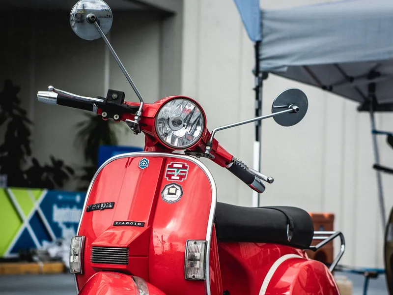 Vintage Vespa sidecar parked on a cobblestone street in Rome